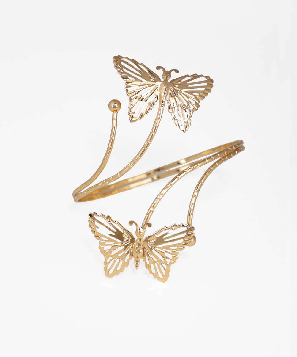 Gold-tone arm cuff with two intricate openwork butterfly designs and a textured band