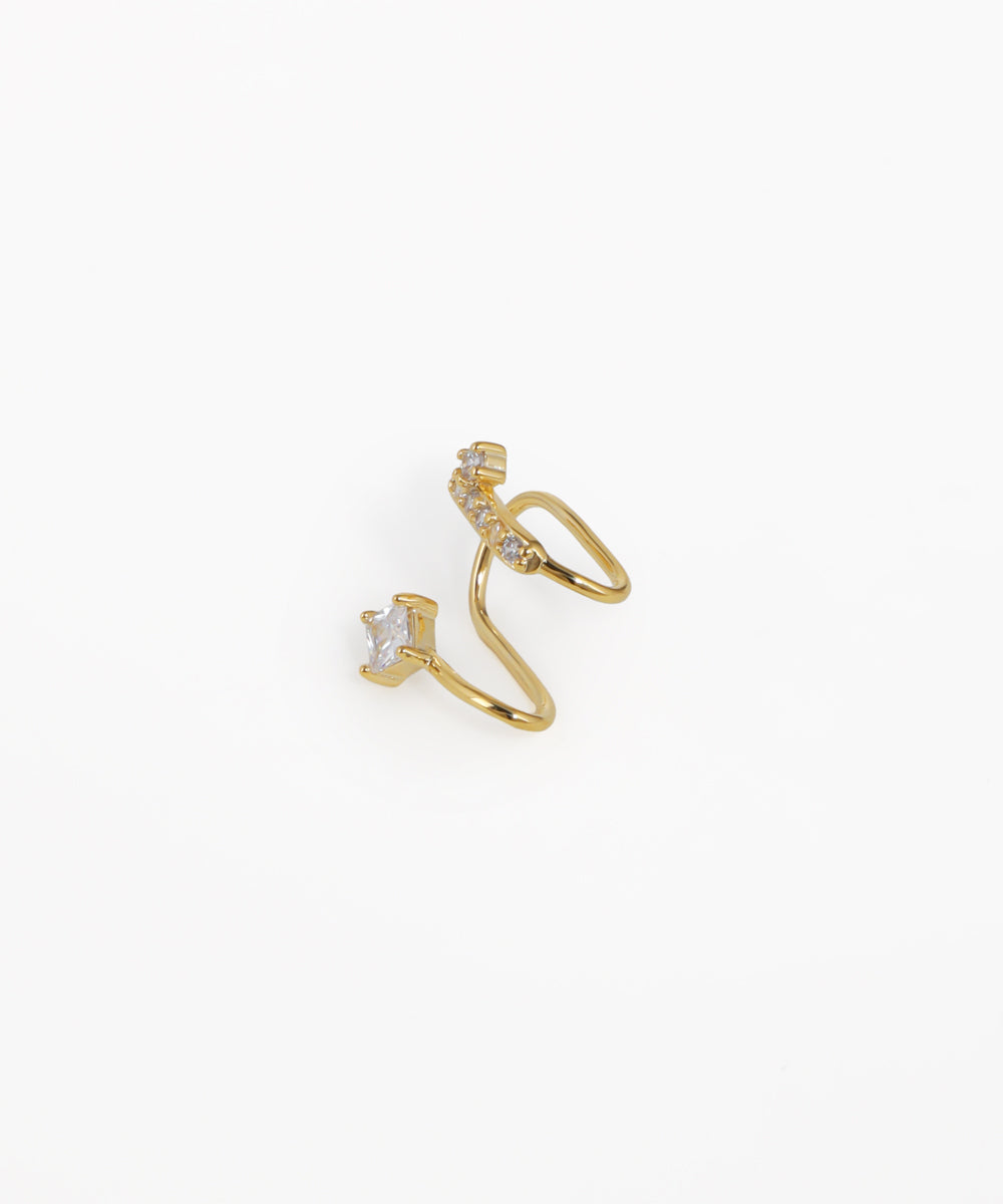 Gold ear cuff with small diamonds on a white background