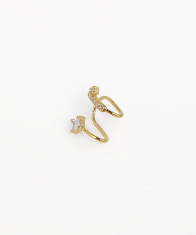 Gold ear cuff with small diamonds on a white background