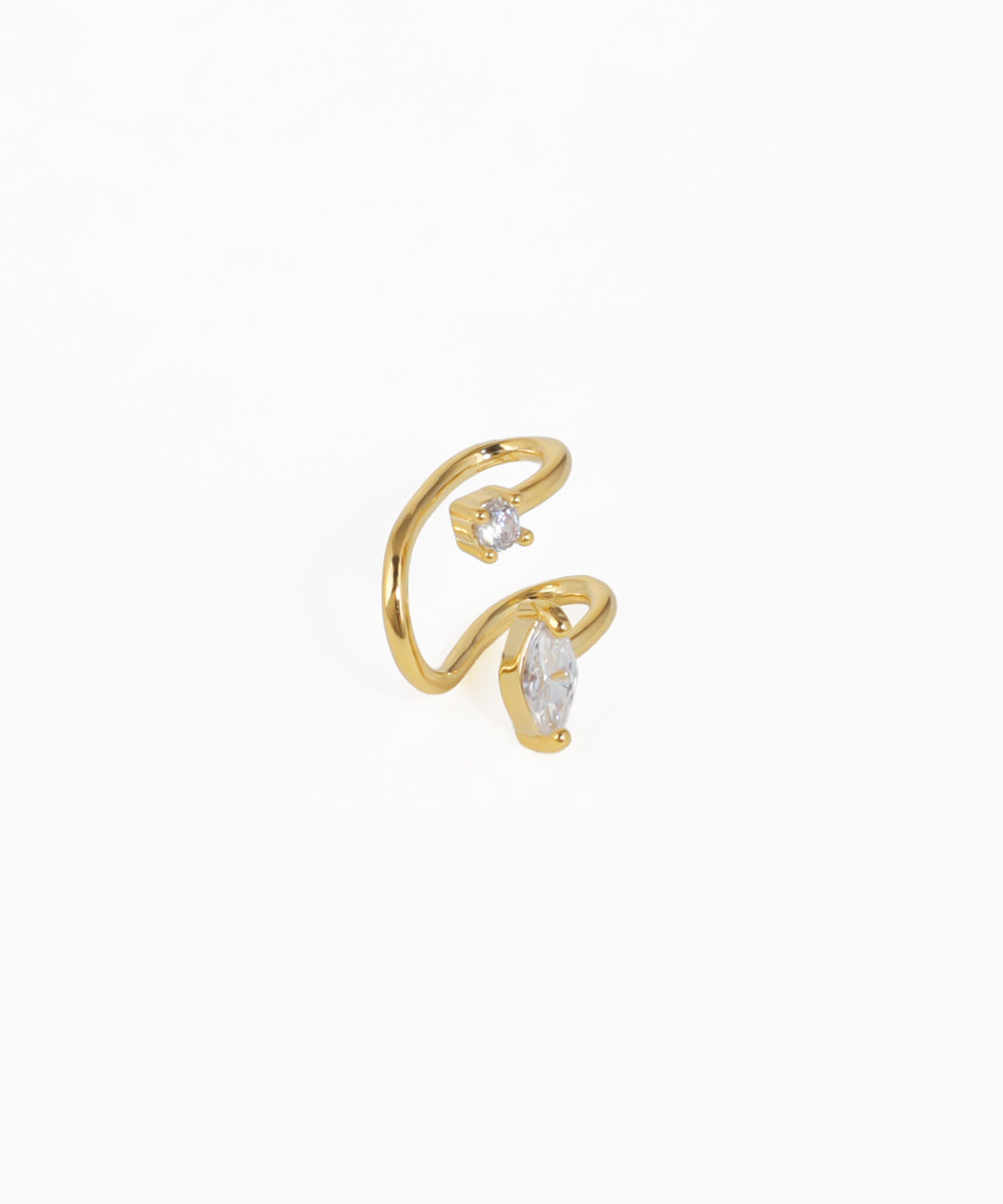 Gold open ring with clear gemstones on a white background