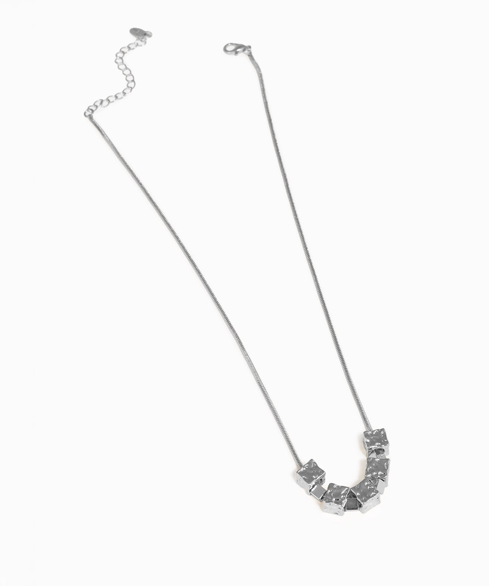 Silver necklace with geometric pendants on a white background
