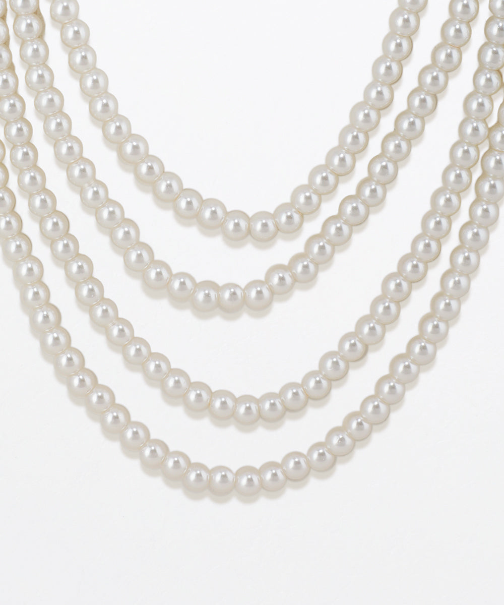 Three strands of pearls on a white background