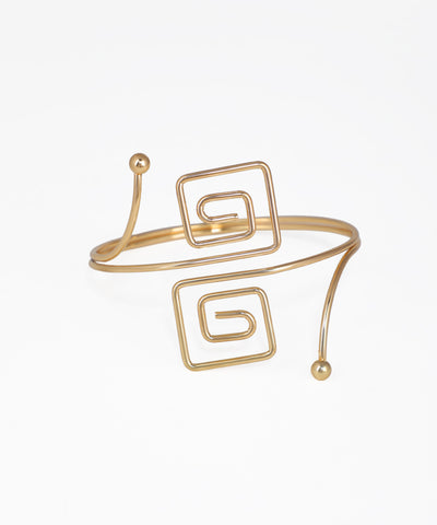 Gold-tone arm cuff with open-ended design and two square spiral motifs