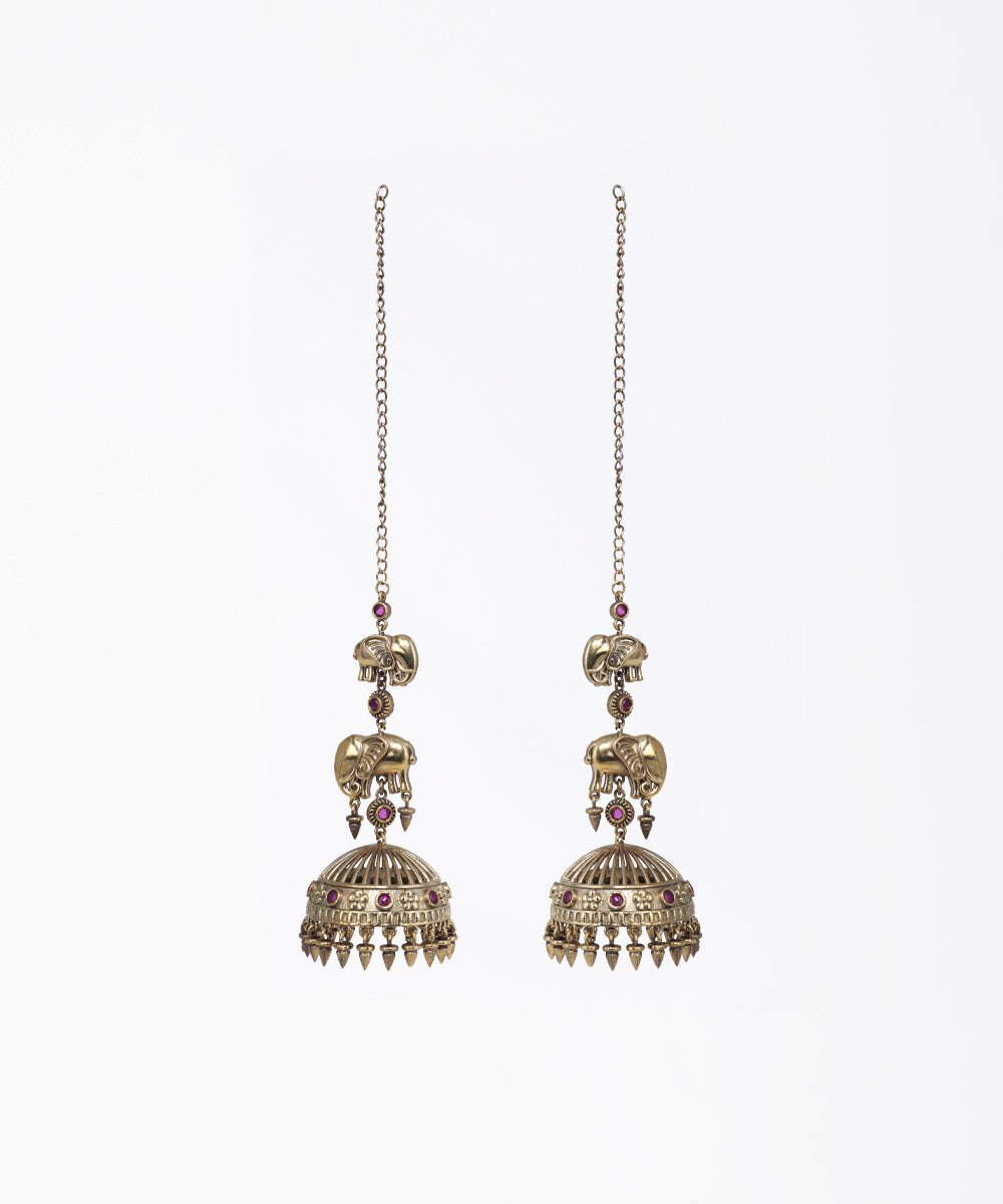 Pair of ornate earrings with intricate designs on a white background