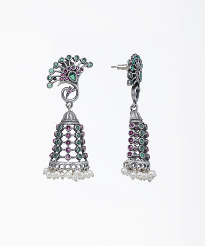 Decorative earrings with gemstones on a white background