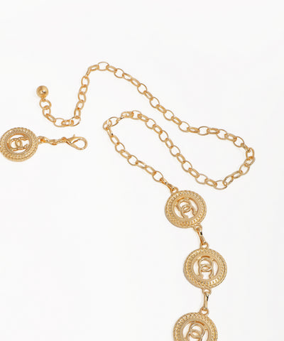 Gold necklace with circular pendants on a white background