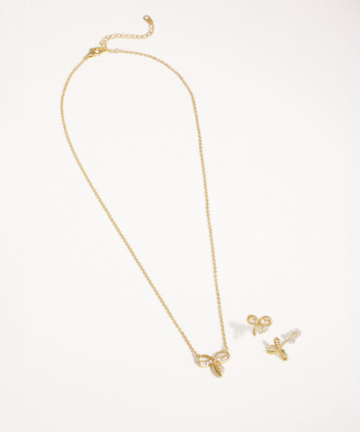 Gold-tone necklace with a knot-shaped pendant set with clear CZ stones and matching small stud earrings.