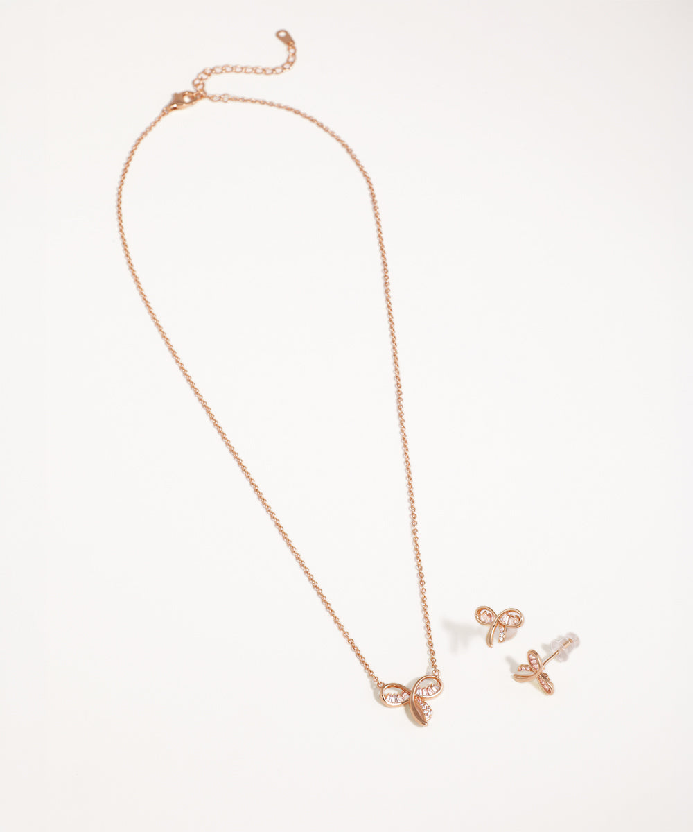 Rose gold necklace and earrings on a white background