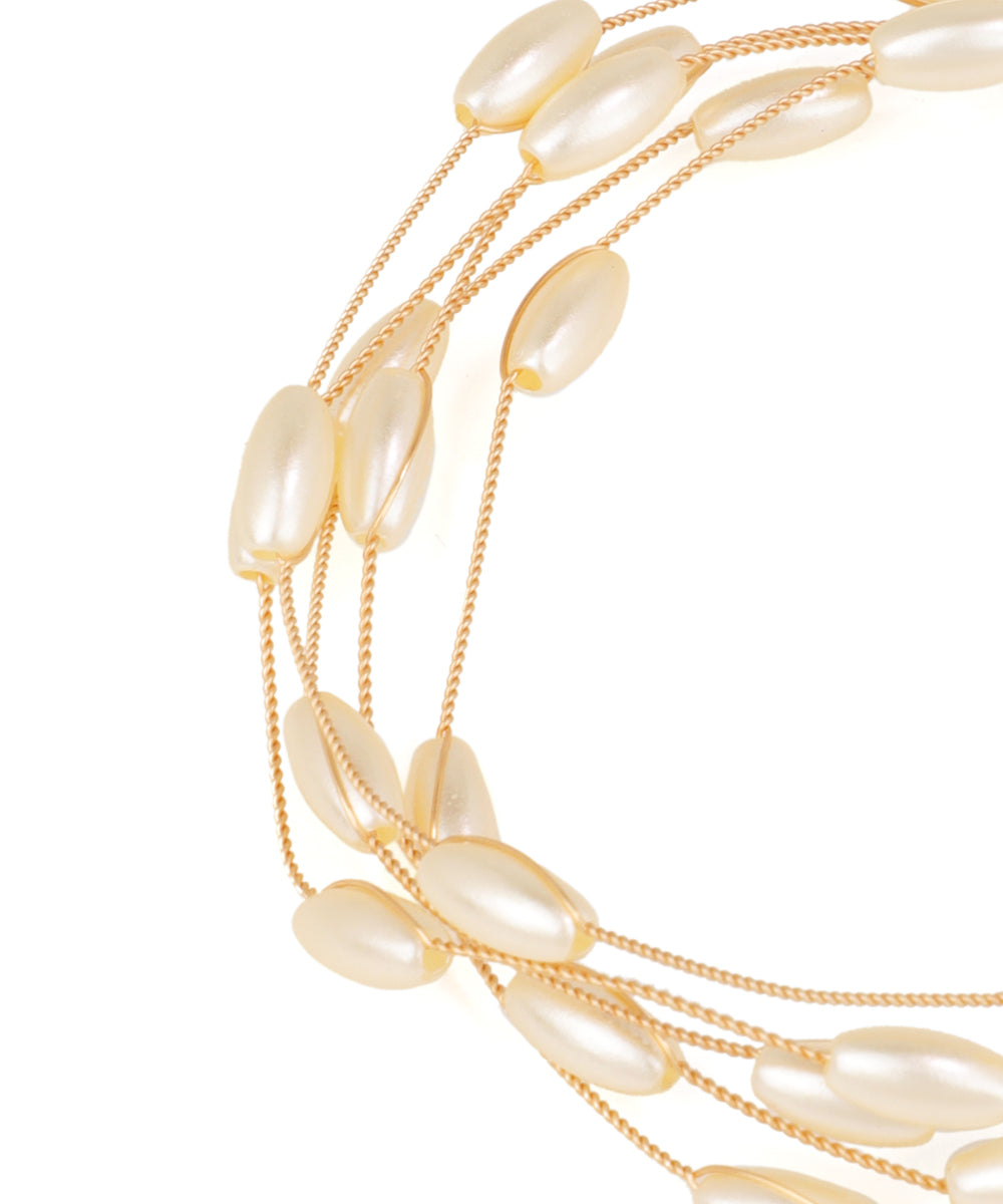 Multi-layered pearl necklace on a white background