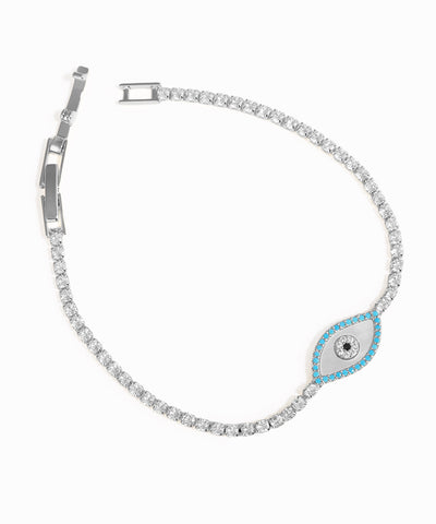 Silver bracelet with a blue evil eye charm on a white background