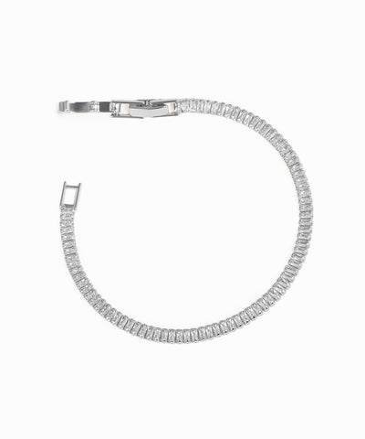 Silver bracelet with clear stones on a white background