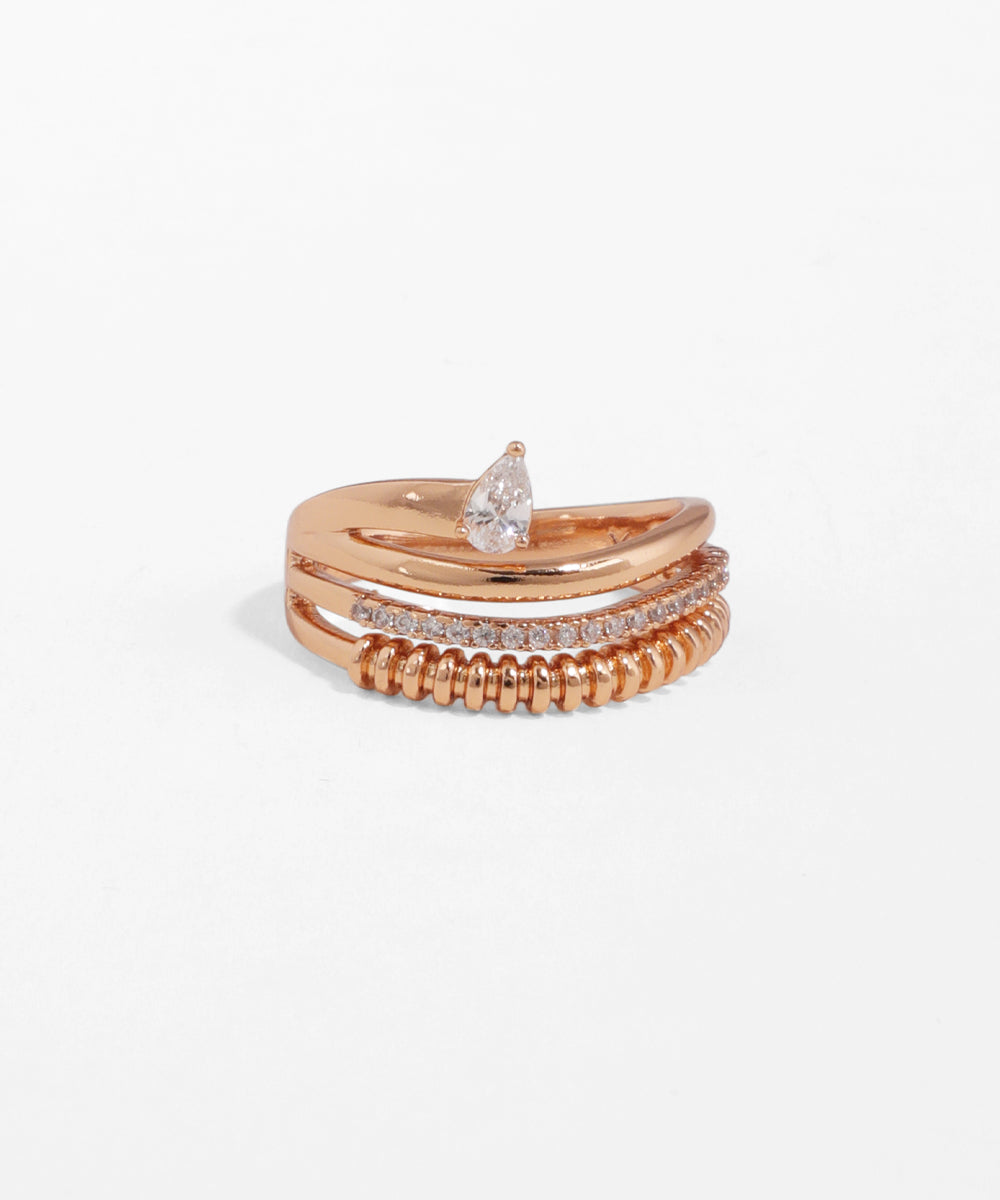Set of rose gold rings with a central diamond on a white background