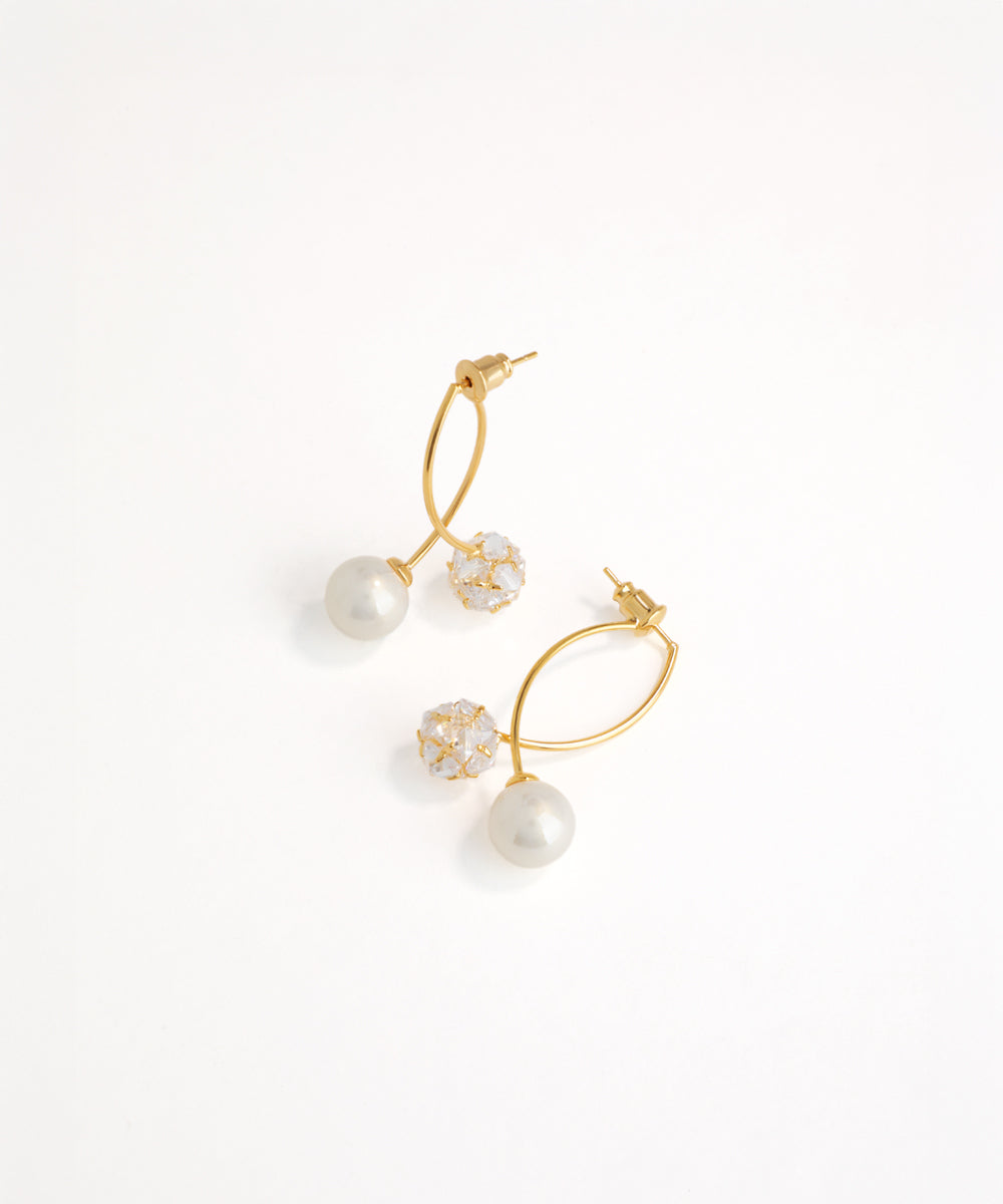 Gold and pearl earrings on a white background