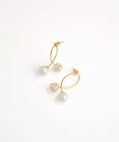 Gold and pearl earrings on a white background