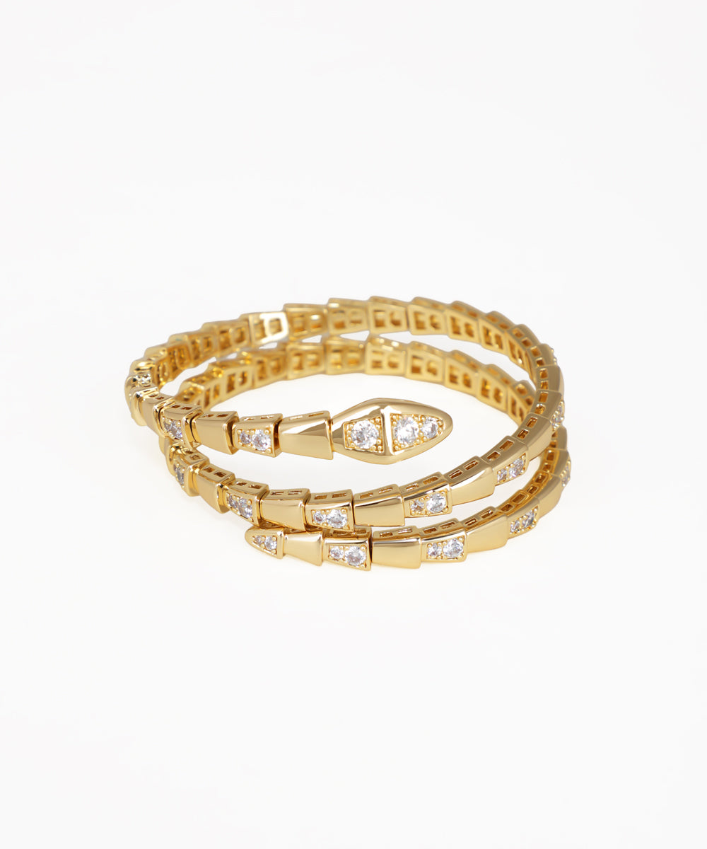 Set of gold bracelets with diamond accents on a white background