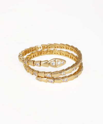 Set of gold bracelets with diamond accents on a white background