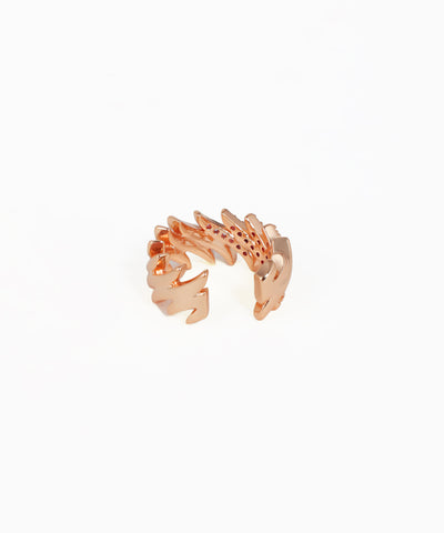 Rose gold ring with a unique design on a white background