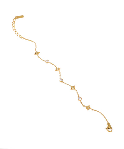 Gold bracelet with star and diamond accents on a white background