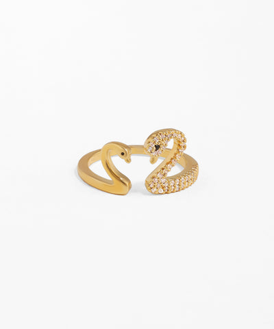 Gold-tone open ring with two swan motifs, one side smooth, one side embellished with clear and black CZ stones.