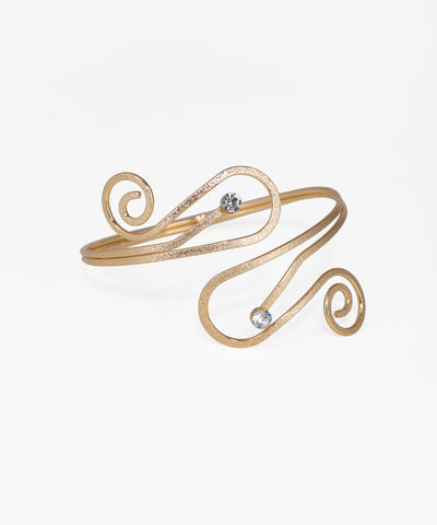 Gold-tone arm cuff with sculptural swirl design and two clear stones