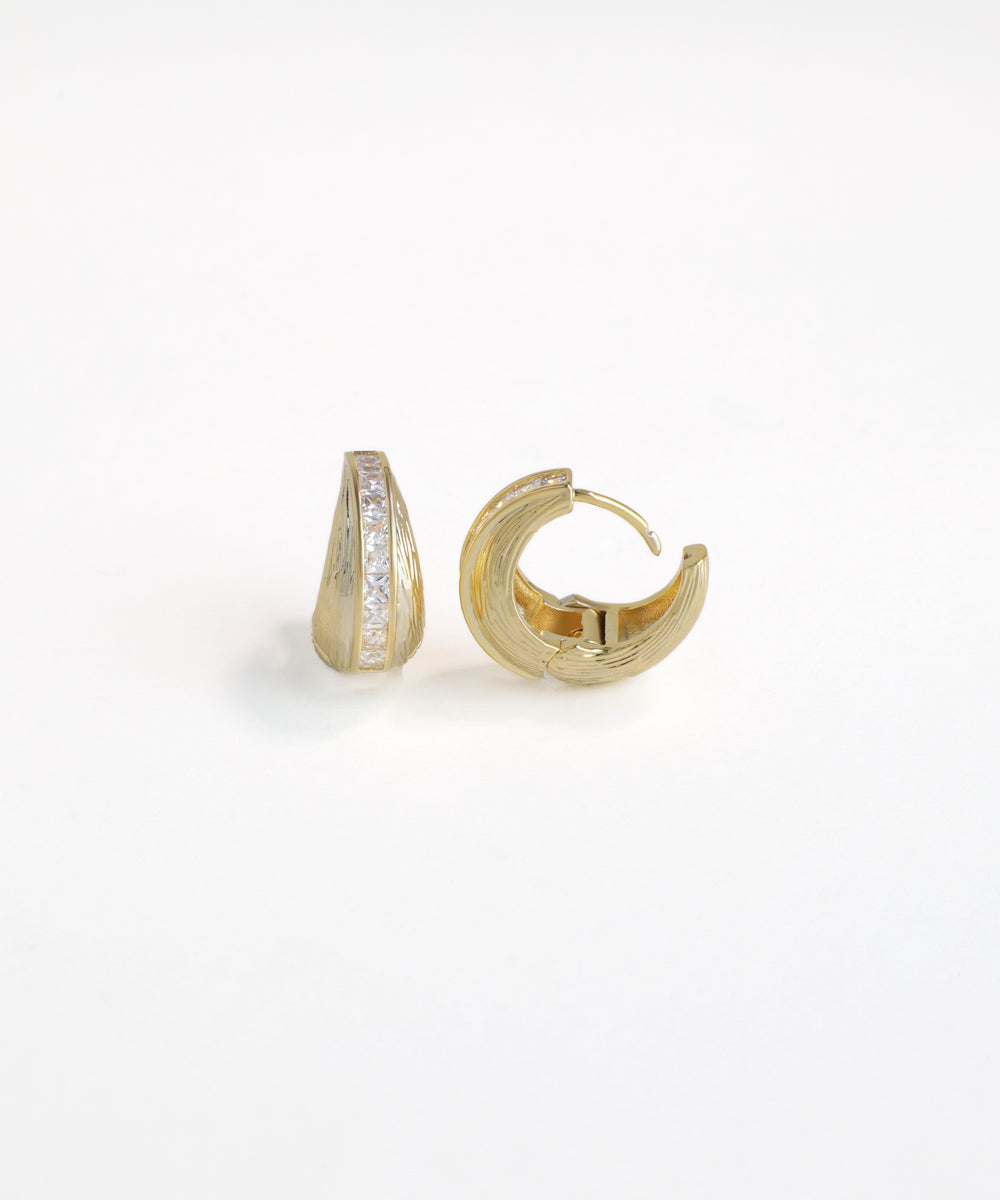 Gold hoop earrings with embedded stones on a white background