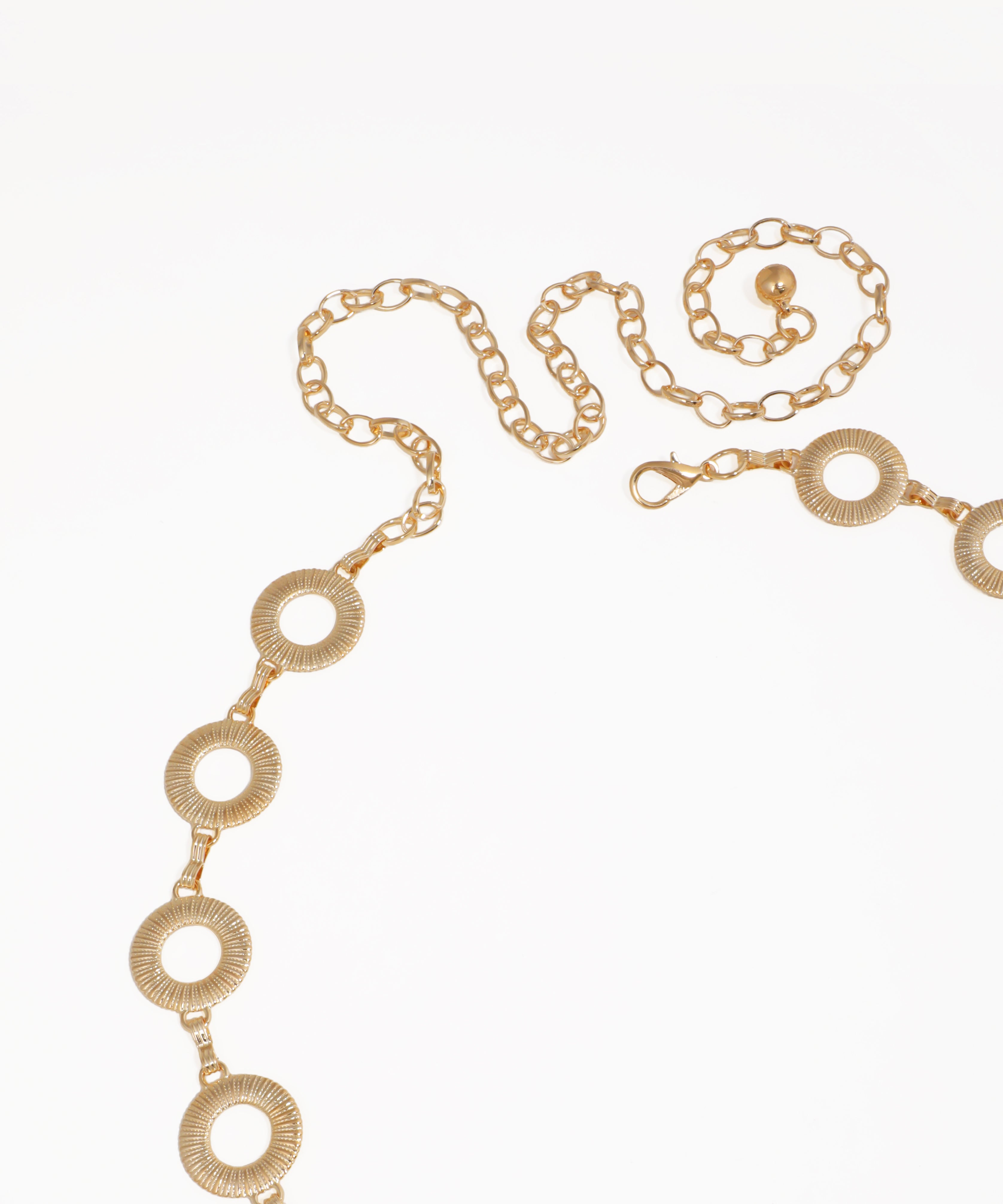 Gold chain necklace with circular design on a white background