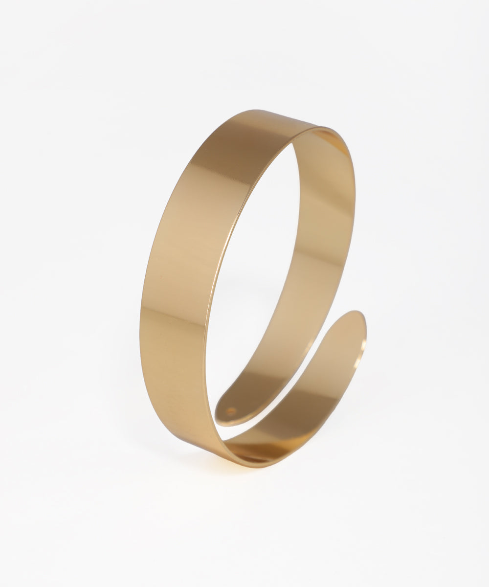Gold-tone arm cuff with wide, polished, open-ended band