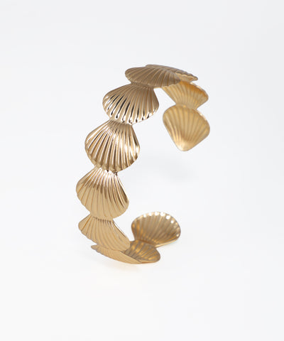 Gold bracelet with shell-like design on a white background