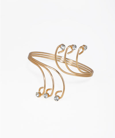 Gold-tone arm cuff with swirling wire design and clear stone accents