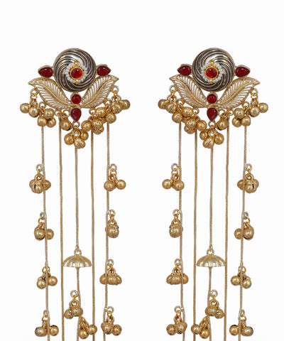 Pair of ornate earrings with gold and red accents on a white background