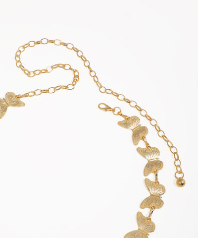 Gold butterfly necklace on a white background