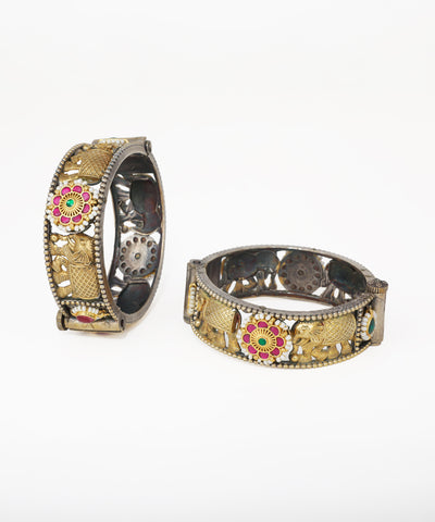 Decorative bangles with intricate designs on a white background