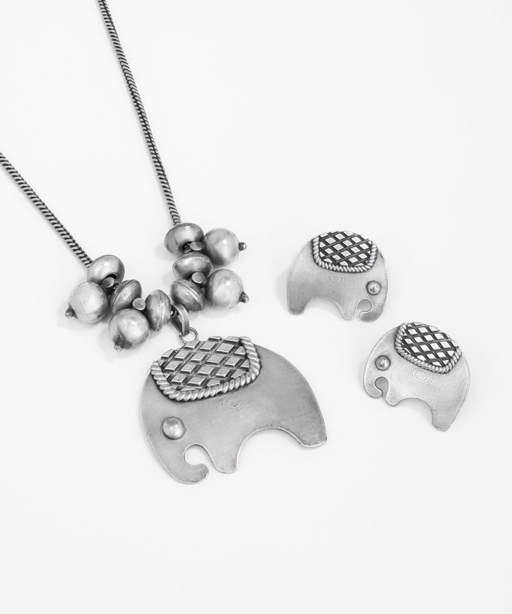 Silver elephant necklace with matching earrings on a white background
