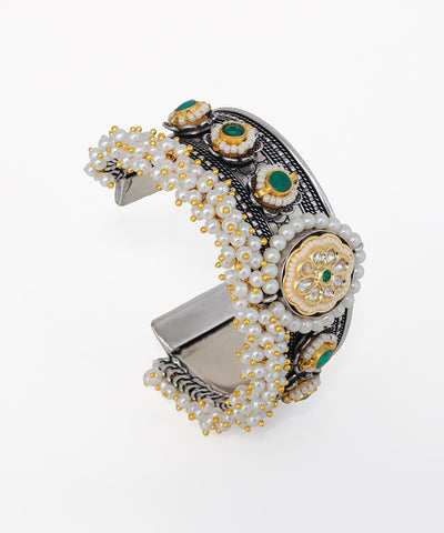 Decorative hair clip with beads and gemstones on a white background