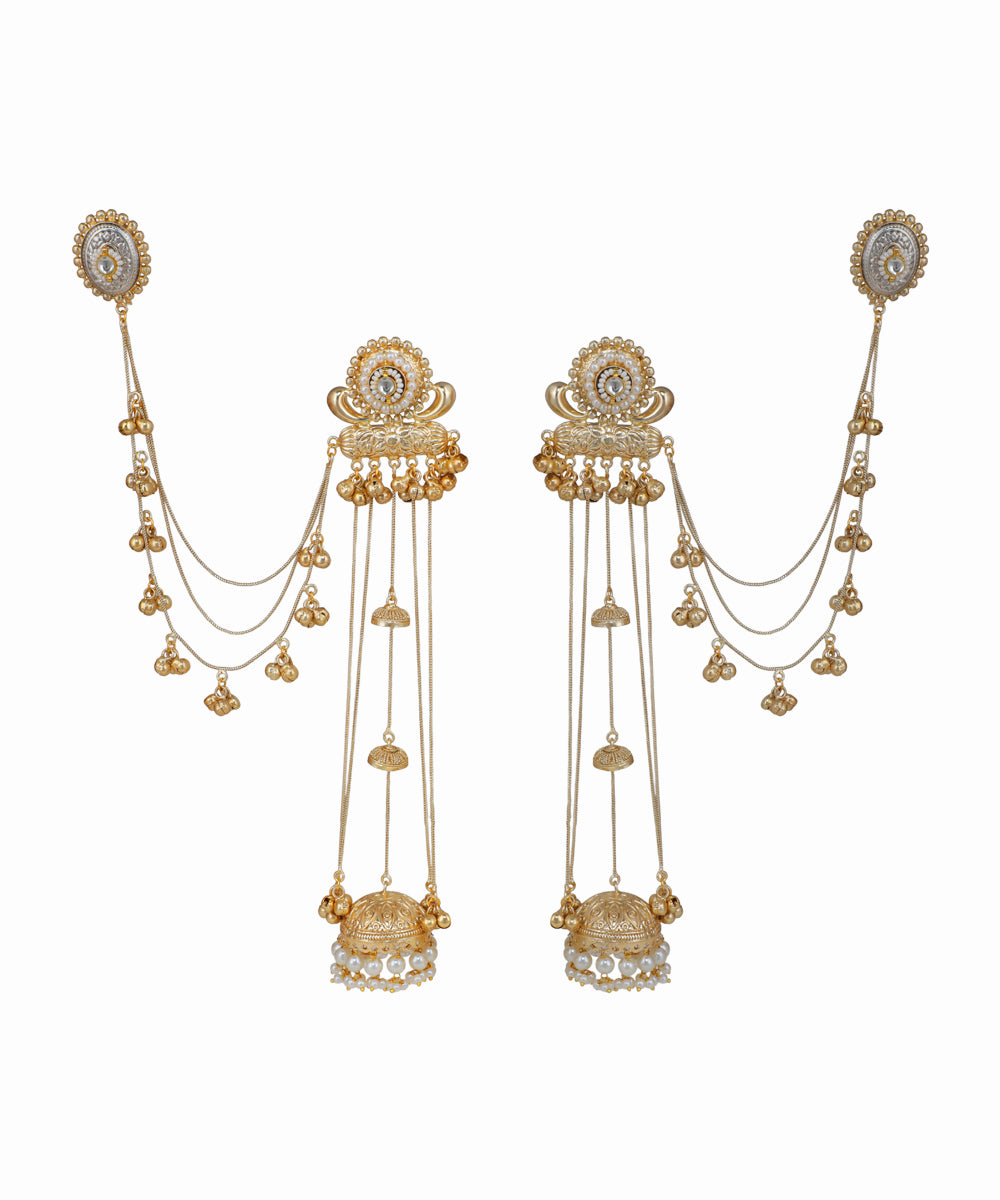 Pair of gold earrings with intricate designs on a white background