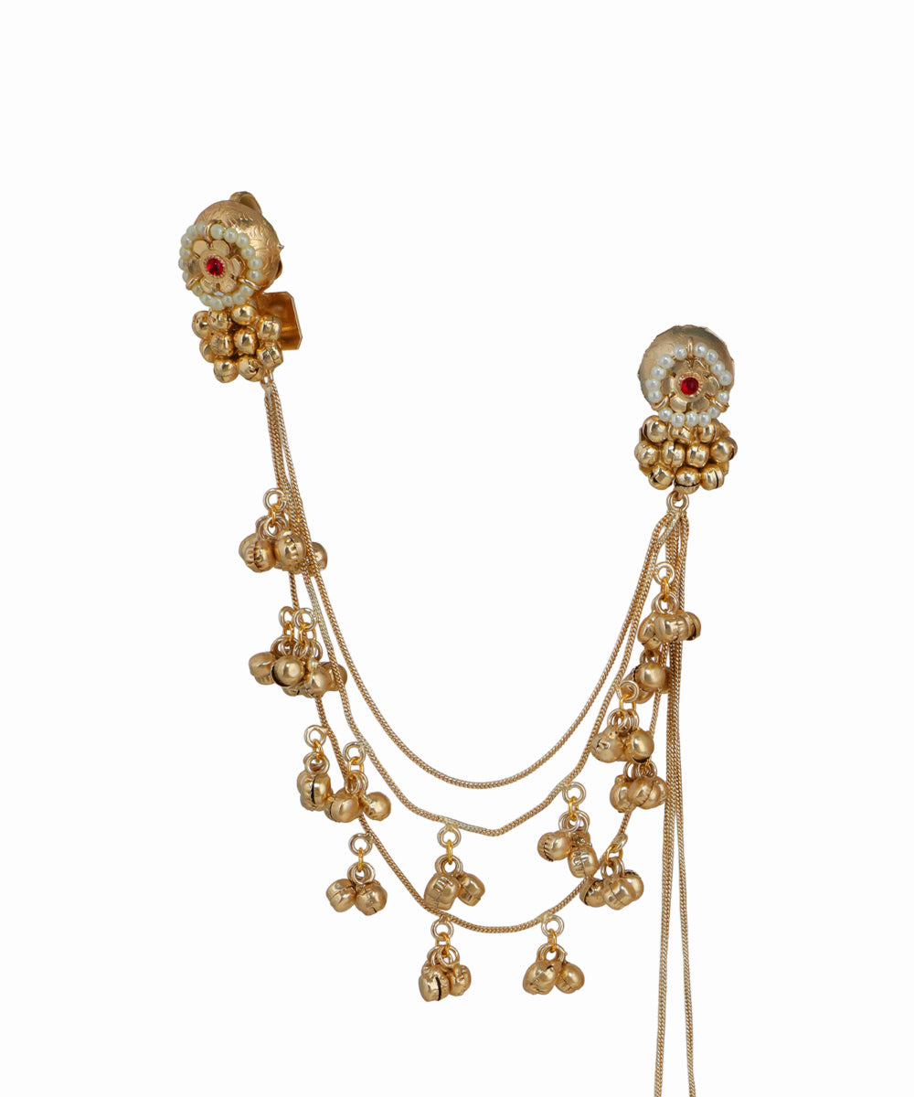 Gold necklace with multiple strands and decorative elements on a white background