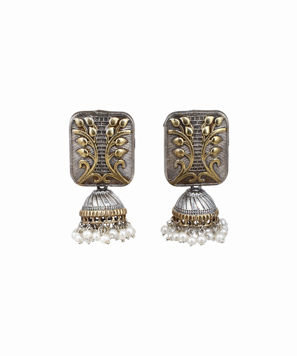 Pair of ornate earrings with intricate designs on a white background