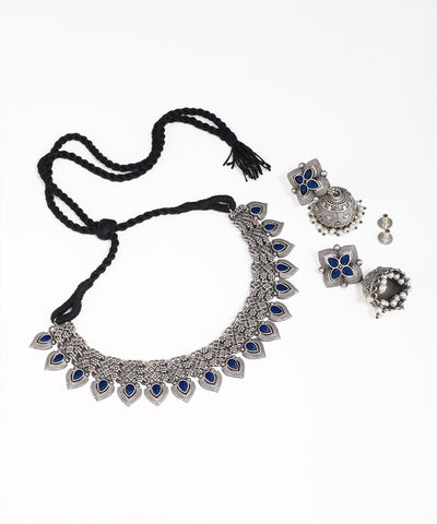Silver necklace with blue stones and matching earrings on a white background