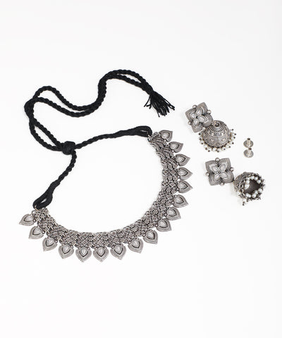 Silver necklace with tassel and matching earrings on a white background
