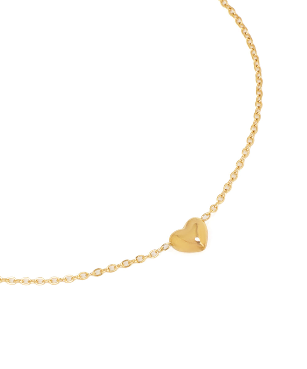 Gold heart-shaped pendant on a chain against a white background