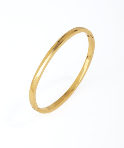 Gold bangle on a white background