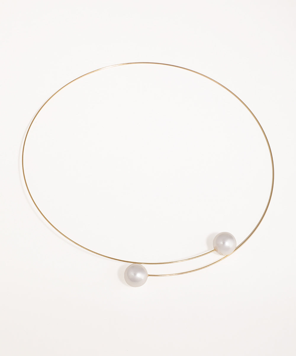 Gold-tone choker necklace with open-end design featuring two faux pearls