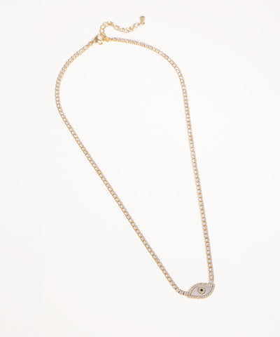 Gold-tone necklace with a thin line of clear stones and a central evil eye charm featuring white enamel and CZ stones.