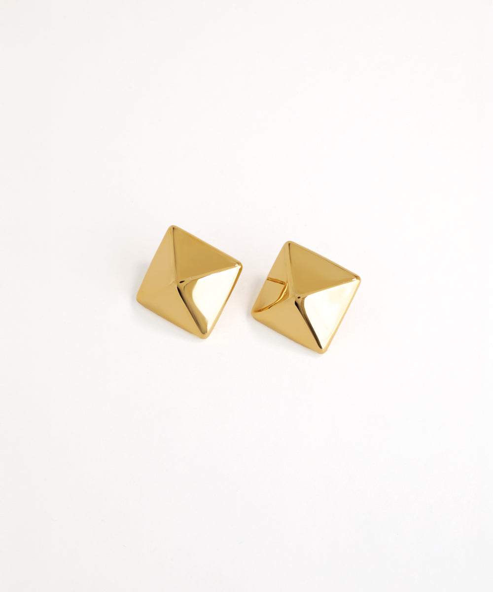Gold pyramid-shaped earrings on a white background
