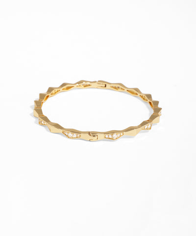 Gold ring with a textured band on a white background