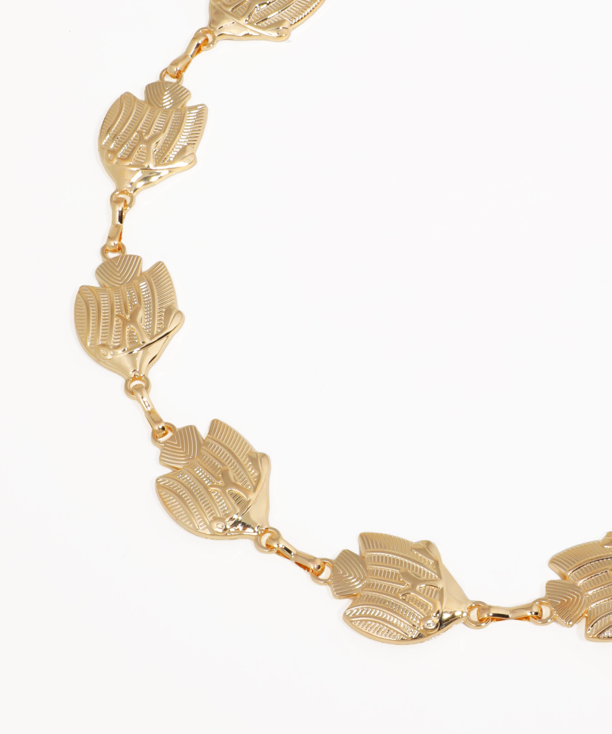 Gold necklace with leaf-like links on a white background