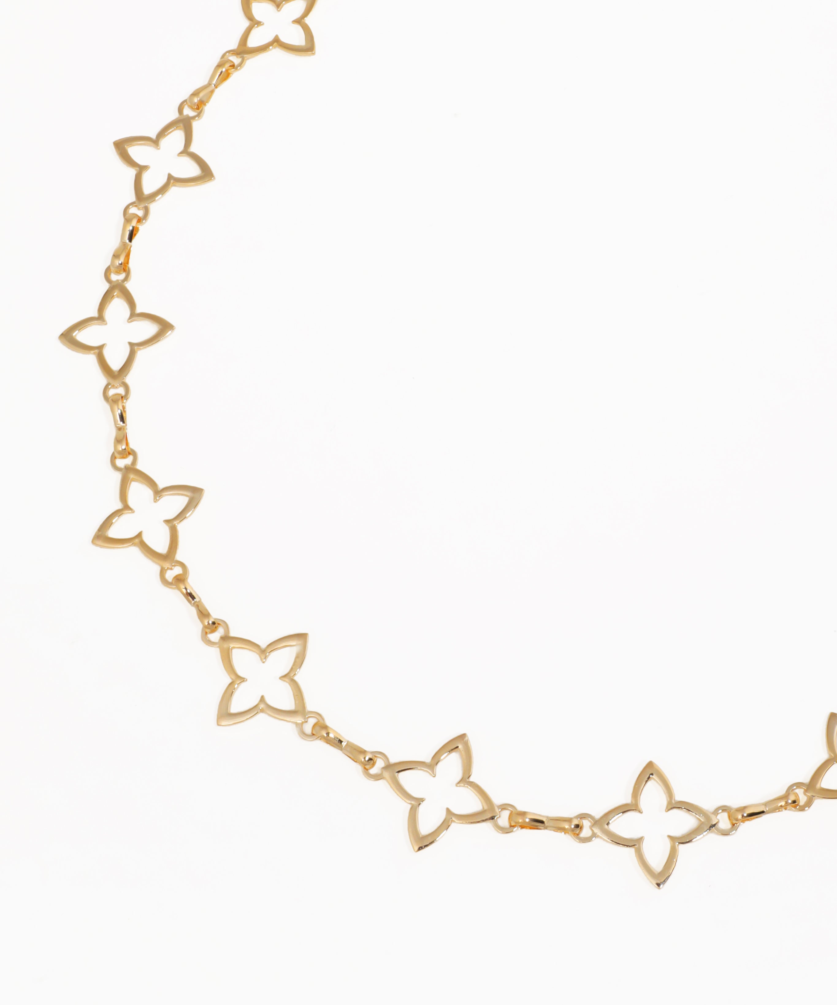 Gold butterfly chain necklace on a white background