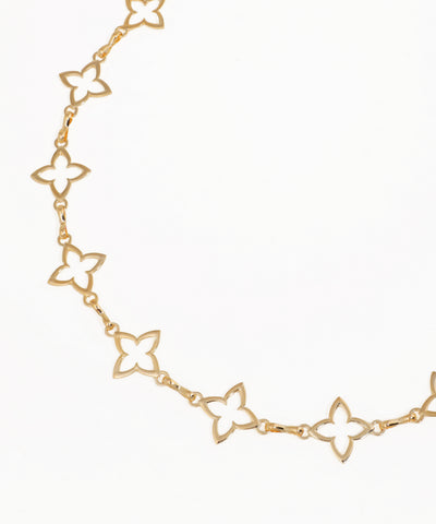Gold butterfly chain necklace on a white background