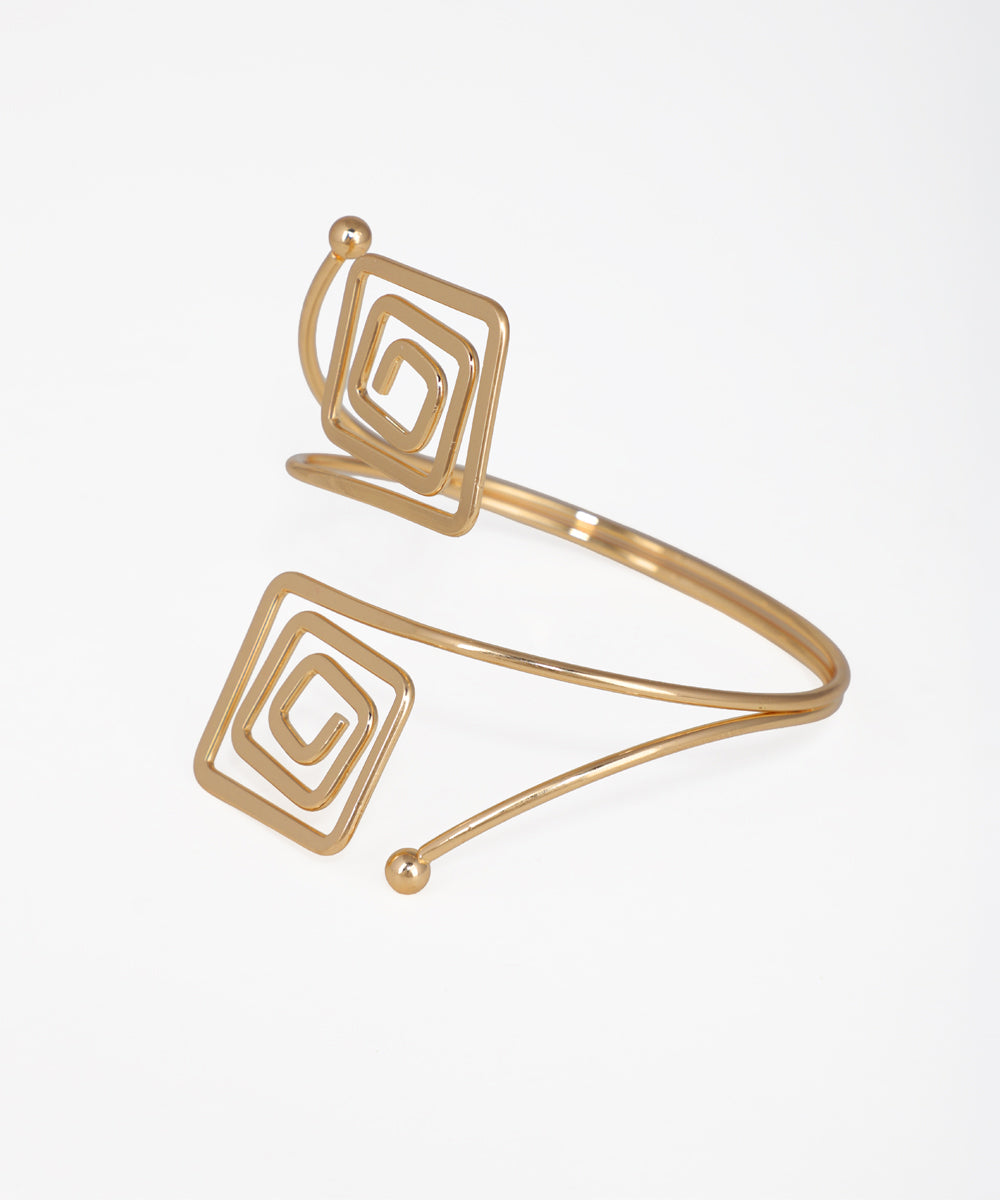 Gold spiral design bracelet on a white background