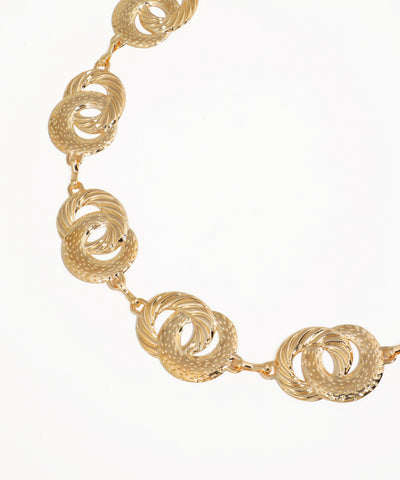 Gold necklace with interlocking circular design on a white background